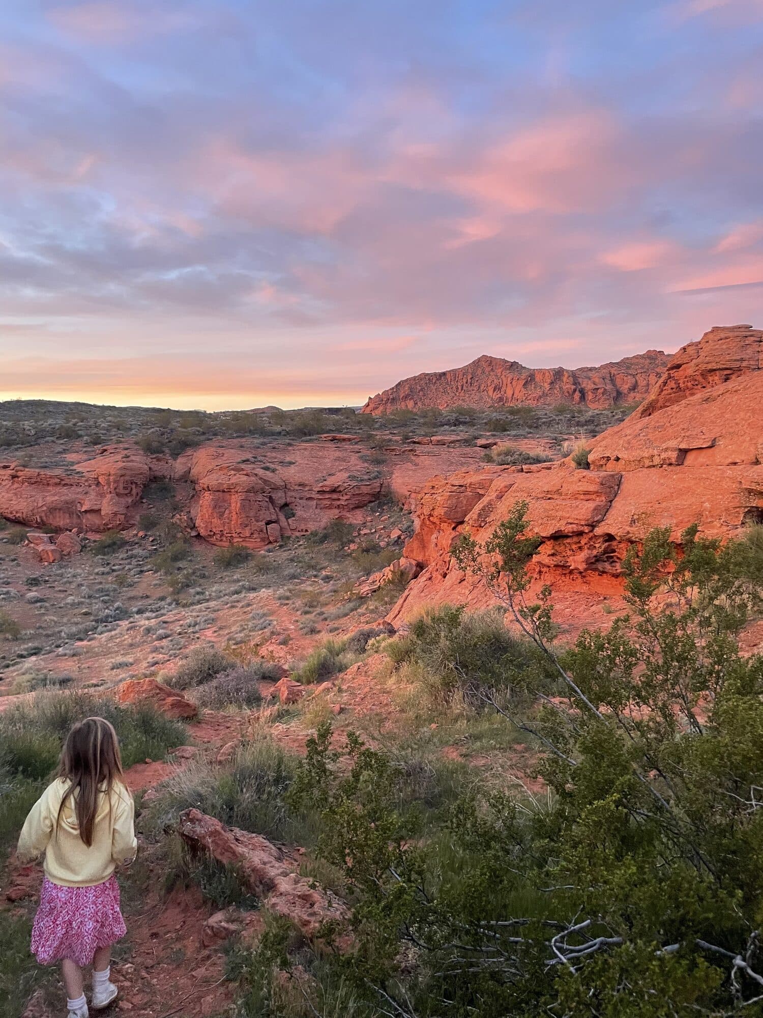 Chandra's daughter walking into the red rocks at sunset