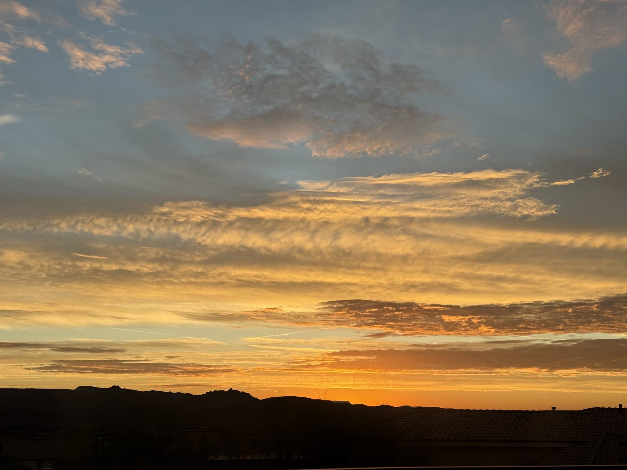 Golden sunset light over layered clouds — ethereal sky